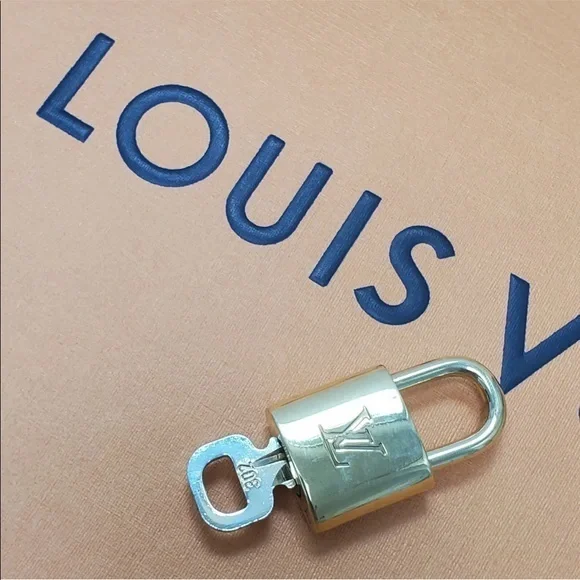 NEAR MINT Louis Vuitton lock and key set.